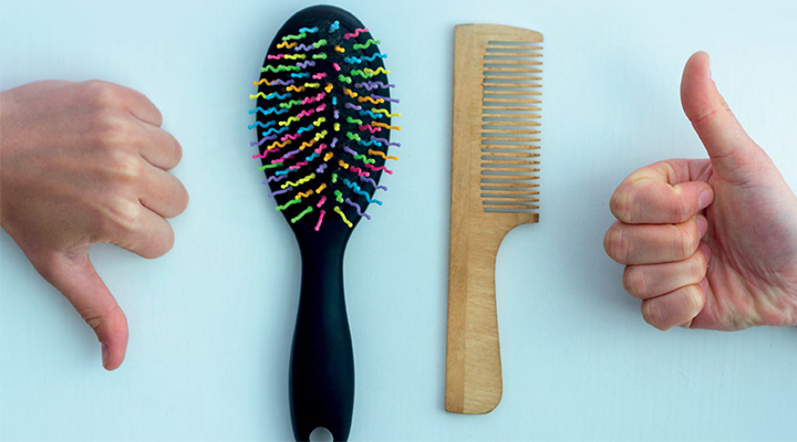 Light blue background with thumbs down next to hair brush with multicolour prongs and thumbs up next to hair comb